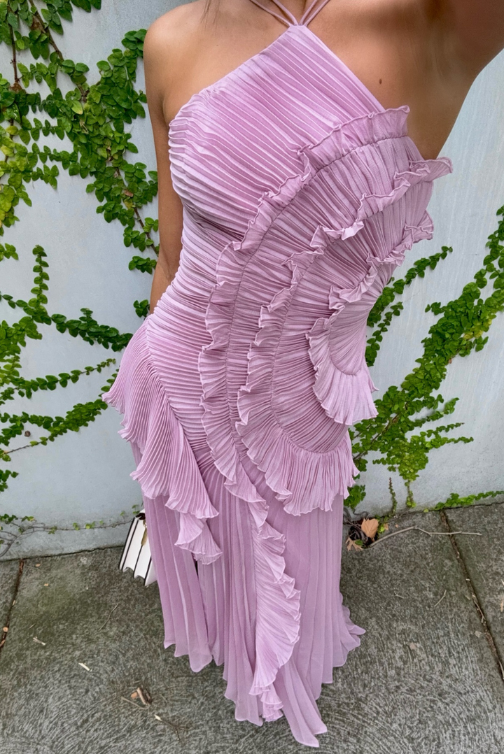 Close-up of the elegant flowy fabric and delicate ruffles on this charming women's dress.