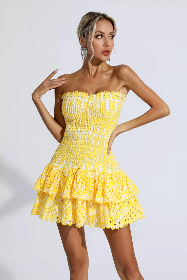 Celebration-ready yellow strapless mini dress, featuring stylish ruffles for women.