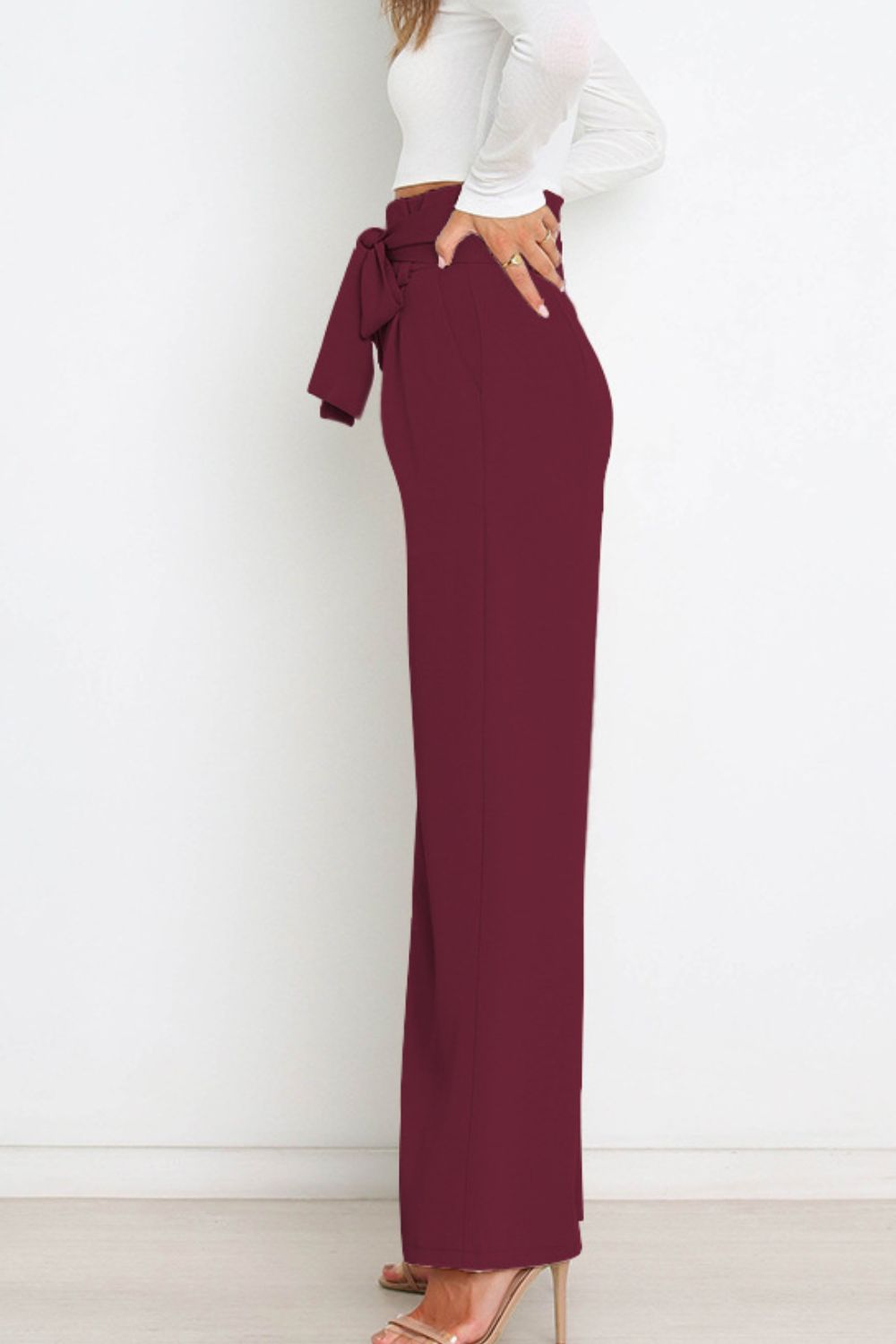Versatile women's paperbag trousers, high waist, wide leg, and elegant bow detail.