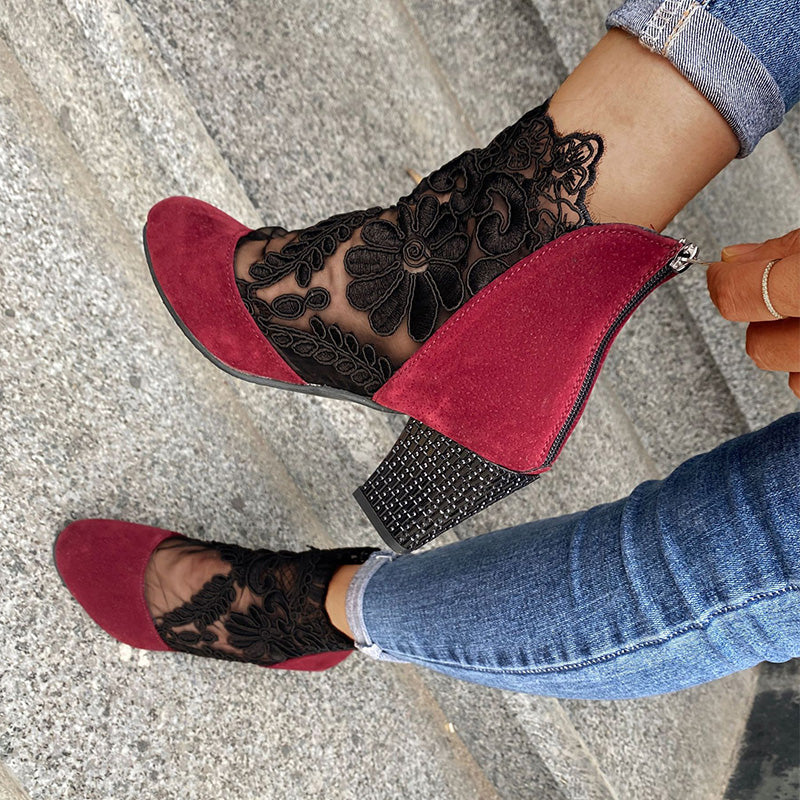 Pair of elegant women's lace embroidered ankle boots with block heels, ideal for dressy occasions & fashion.