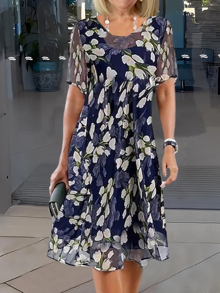 Women's floral A-line midi dress with a round neck, perfect for summer casual wear.