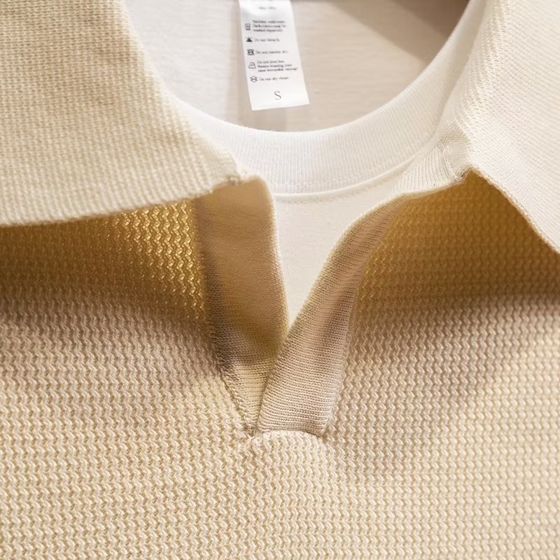 Close-up of men's ribbed knit polo sweater, showcasing the elegant texture, suitable for winter fashion.