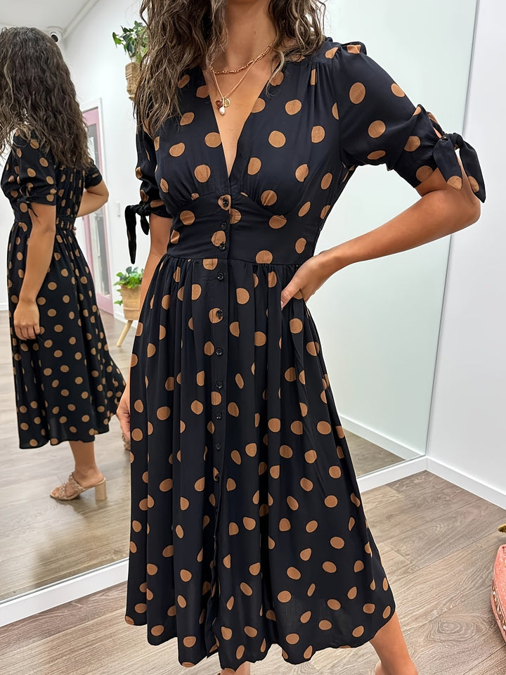 Elegant women's black polka dot midi dress with v-neck and stylish tie sleeves, perfect for summer occasions.