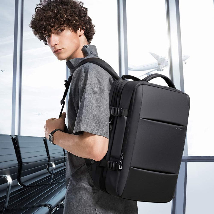 Anti-theft travel bag, 26-45L expandable, waterproof, unisex, with specialized laptop sleeve.
