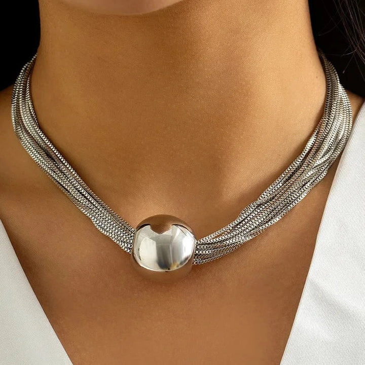 Elegant silver layered necklace for women, featuring shiny chains & pearl accents, a sophisticated fashion accessory.