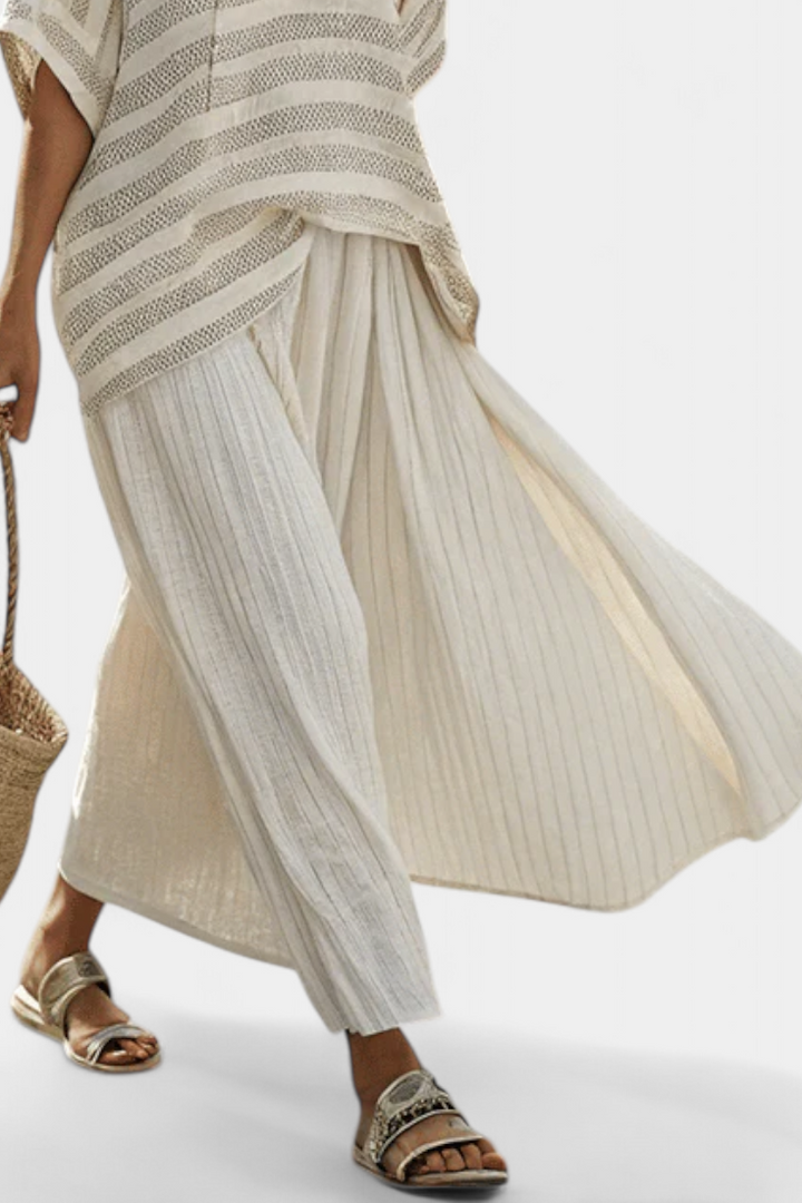 Stylish women's striped two-piece summer outfit featuring a patterned top & comfortable flowing wide-leg pants.