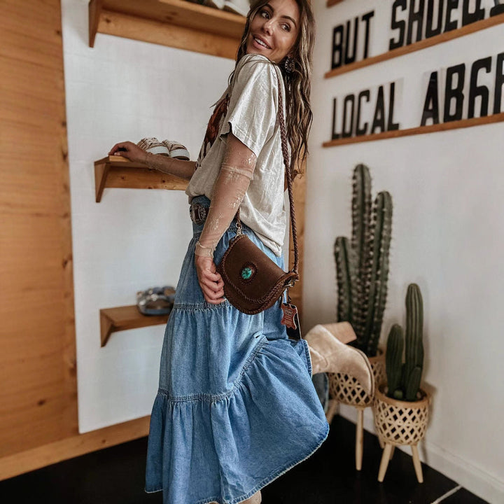 Flared women's tiered maxi skirt featuring a chic button front and fashionable raw hem for versatile styling.