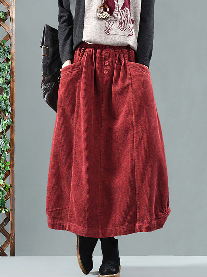 Women's flowy pleated maxi skirt with functional pockets & chic button-front detail, perfect for work or casual.