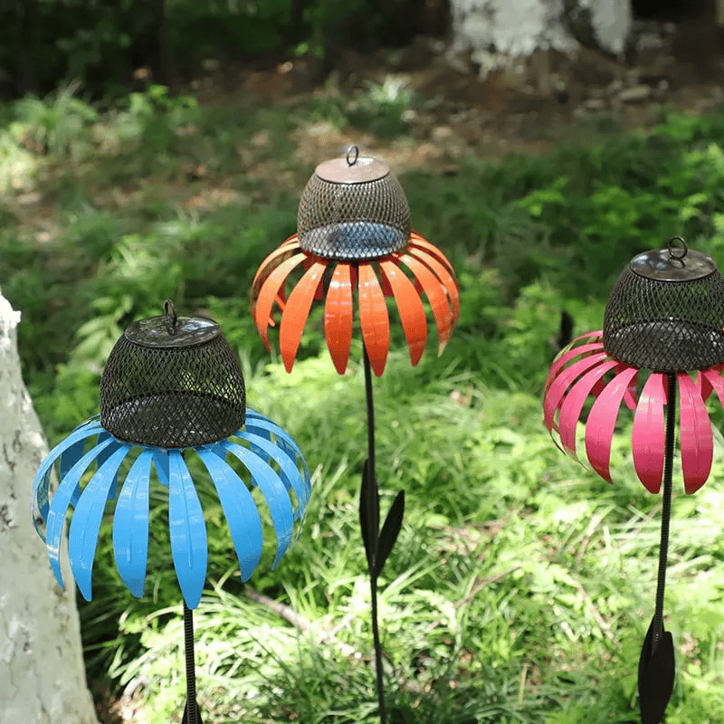 Ornate metal flower bird feeder house, enhancing any garden's outdoor living space.