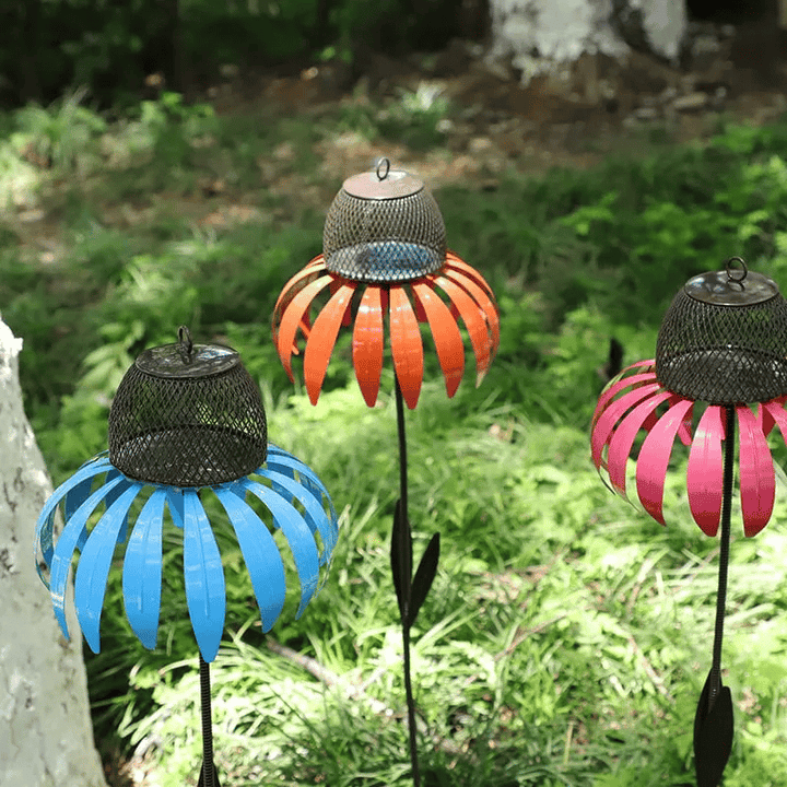 Ornate metal flower bird feeder house, enhancing any garden's outdoor living space.
