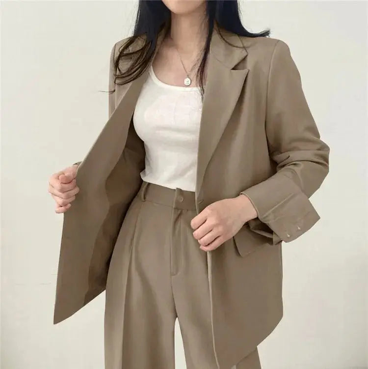 Back view of women's chic trouser set, flattering fit for business attire.