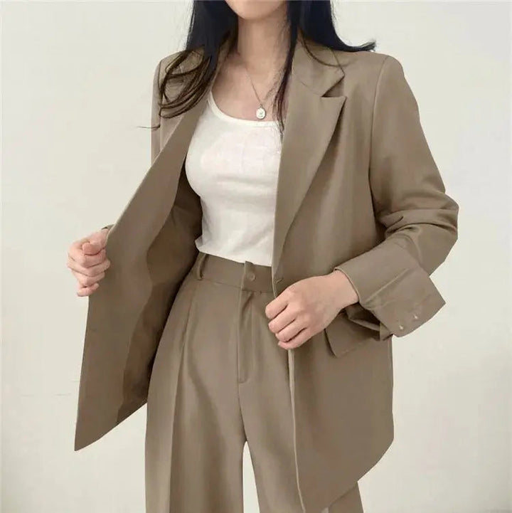 Back view of women's chic trouser set, flattering fit for business attire.