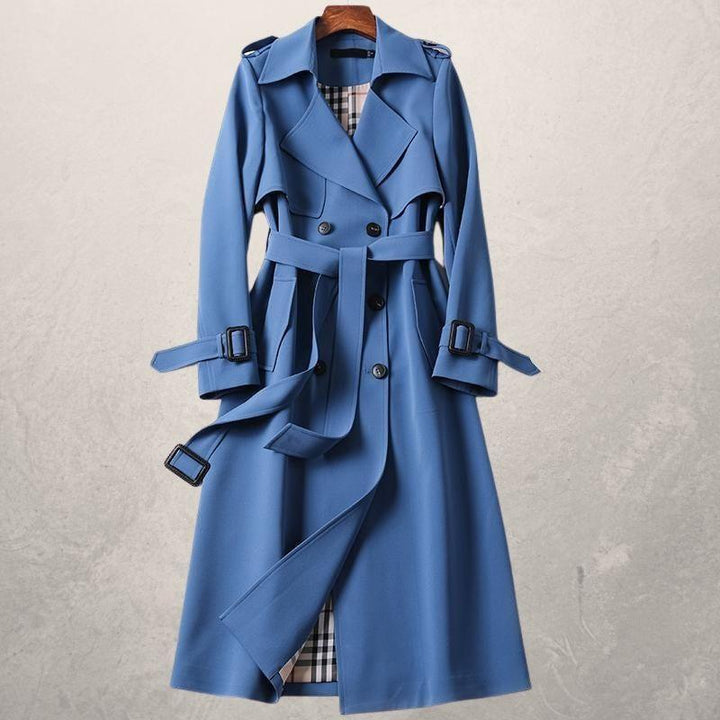 Elegant women's double-breasted long trench coat with lapels & waist belt. Classic outerwear style.