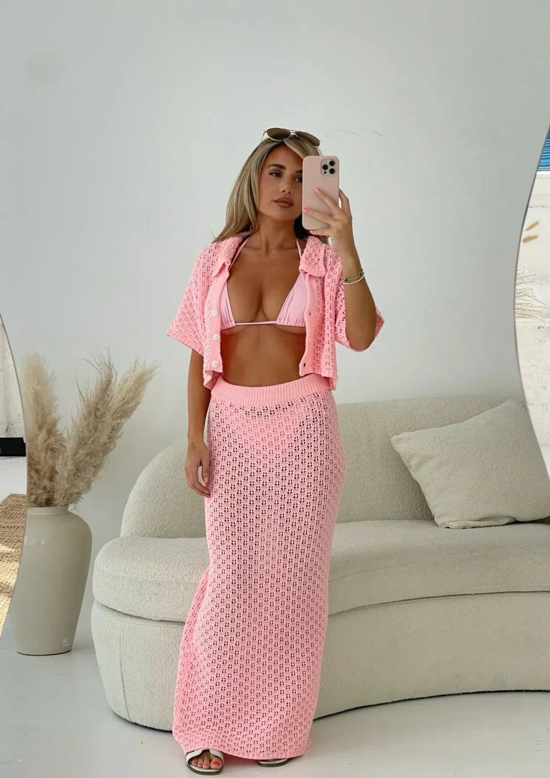 Vacation-ready women's two-piece skirt & cardigan set, a chic summer holiday outfit for the beach.