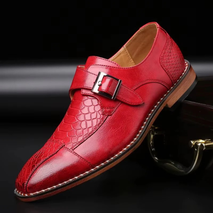 Close-up: Men's crocodile embossed monk strap shoe showcasing rich texture, buckle, and elegant design.