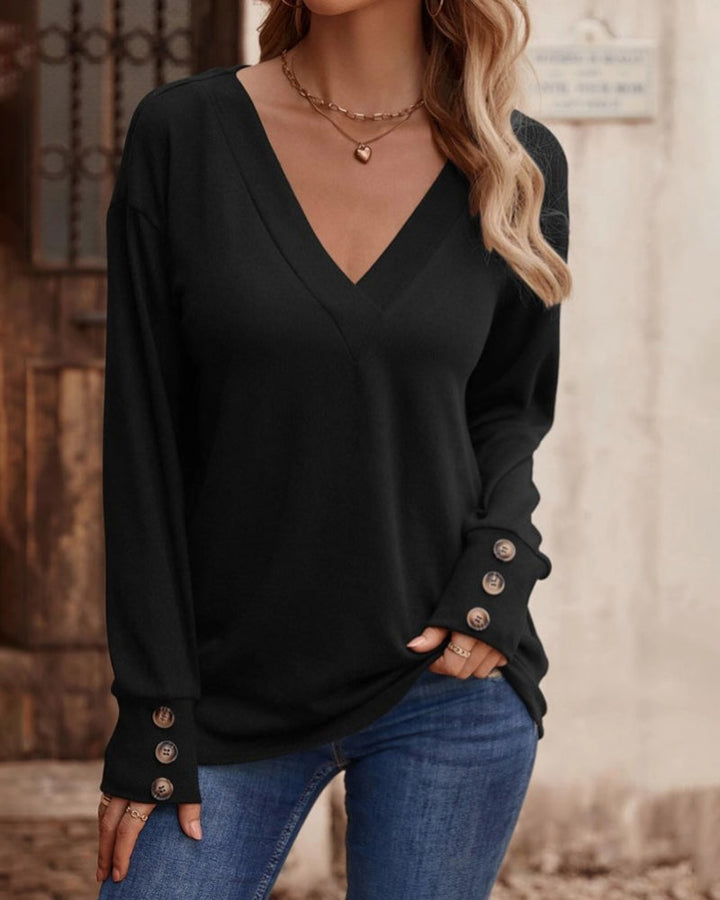 Women's solid V-neck long sleeve top, perfect for casual or office wear. Features stylish button detail.