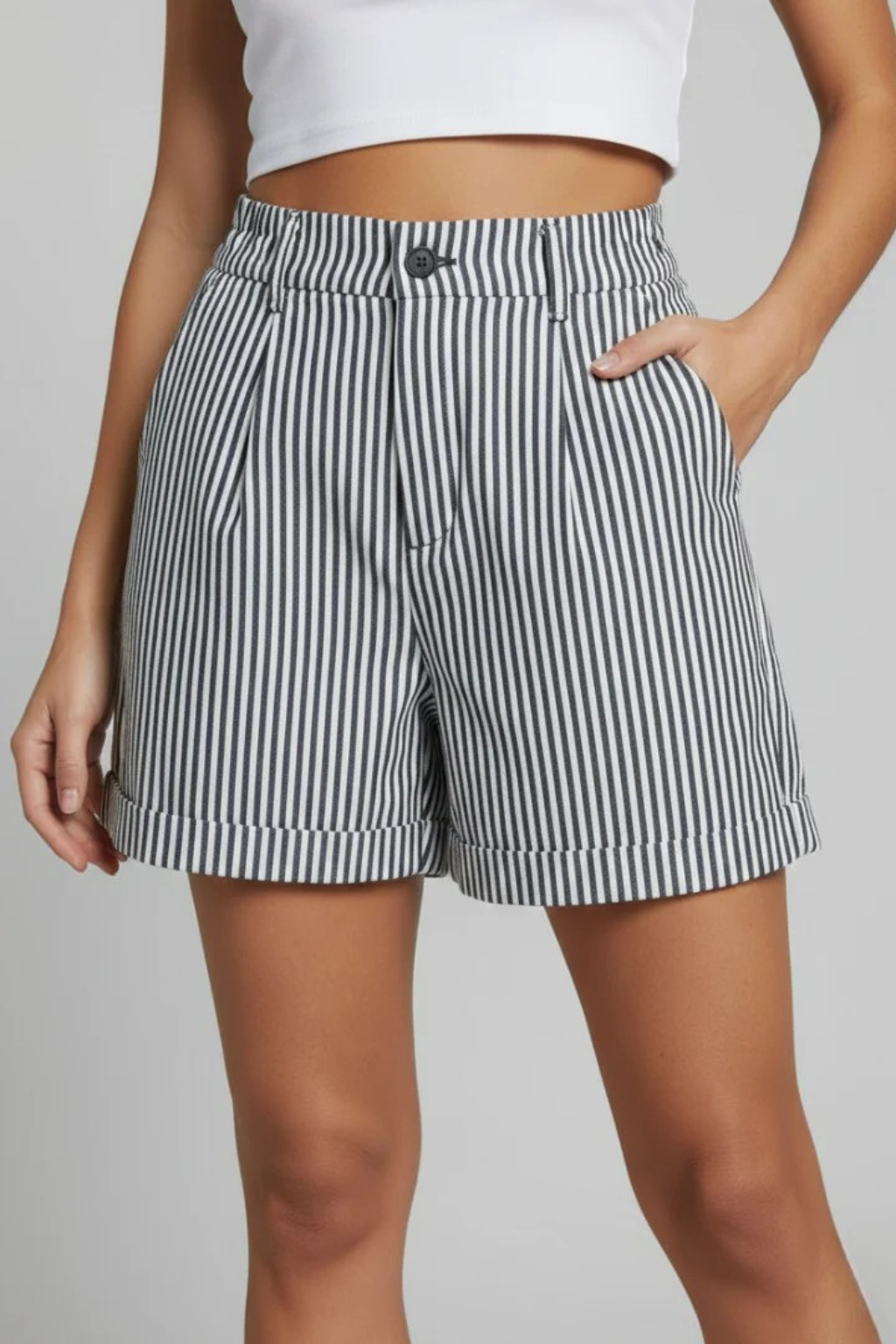 Feminine striped high waist tailored shorts with button detail, essential for a modern summer fashion wardrobe.