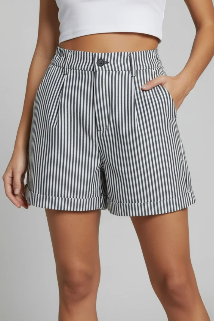 Feminine striped high waist tailored shorts with button detail, essential for a modern summer fashion wardrobe.