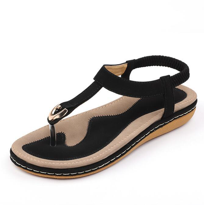Versatile ladies' T-strap flat sandals, ideal for casual wear, featuring an elastic back and cushioning.