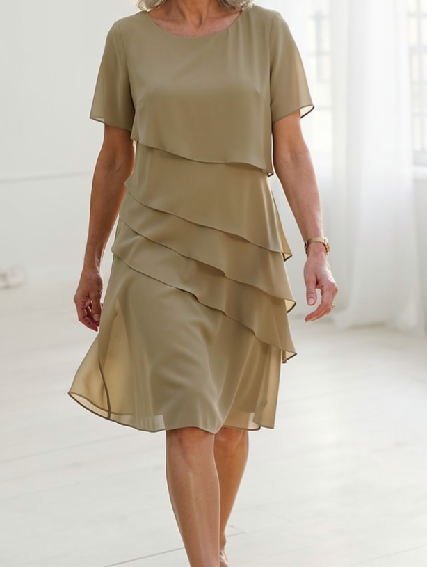 Women's elegant ruffled midi dress with a flowing silhouette and sheer sleeves for effortless spring fashion.