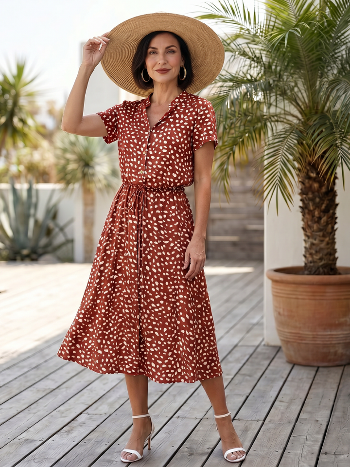 Side view of model in a flowy printed midi dress with belt, perfect for women's summer fashion & everyday wear.