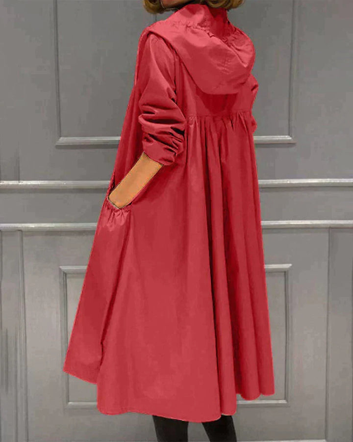 Fashionable women's knee-length waterproof rain jacket, essential stylish rainwear for modern ladies.
