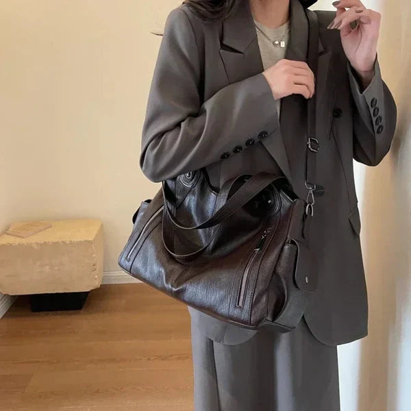 Stylish women's faux leather shoulder bag in a classic color, a versatile everyday tote and travel bag.