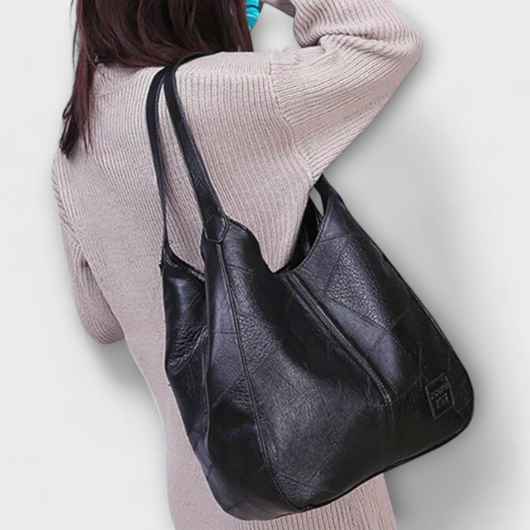 Women's classic vintage leather tote handbag, spacious and stylish for everyday carry.