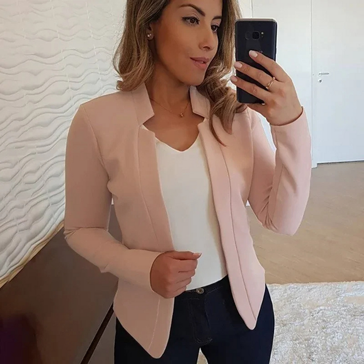 Woman in a professional setting, wearing a stylish slim fit blazer for elegant workwear.