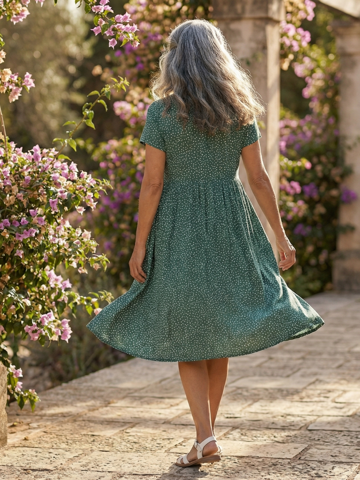 Chic women's dotted summer dress with a relaxed, flowy fit. Short sleeves, round neck, and knee length for comfort.