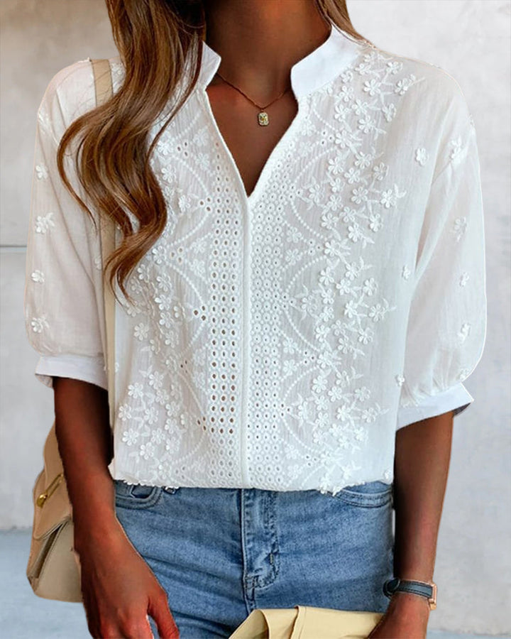 Full-length view of a women's white puff sleeve blouse, showcasing its stylish design.