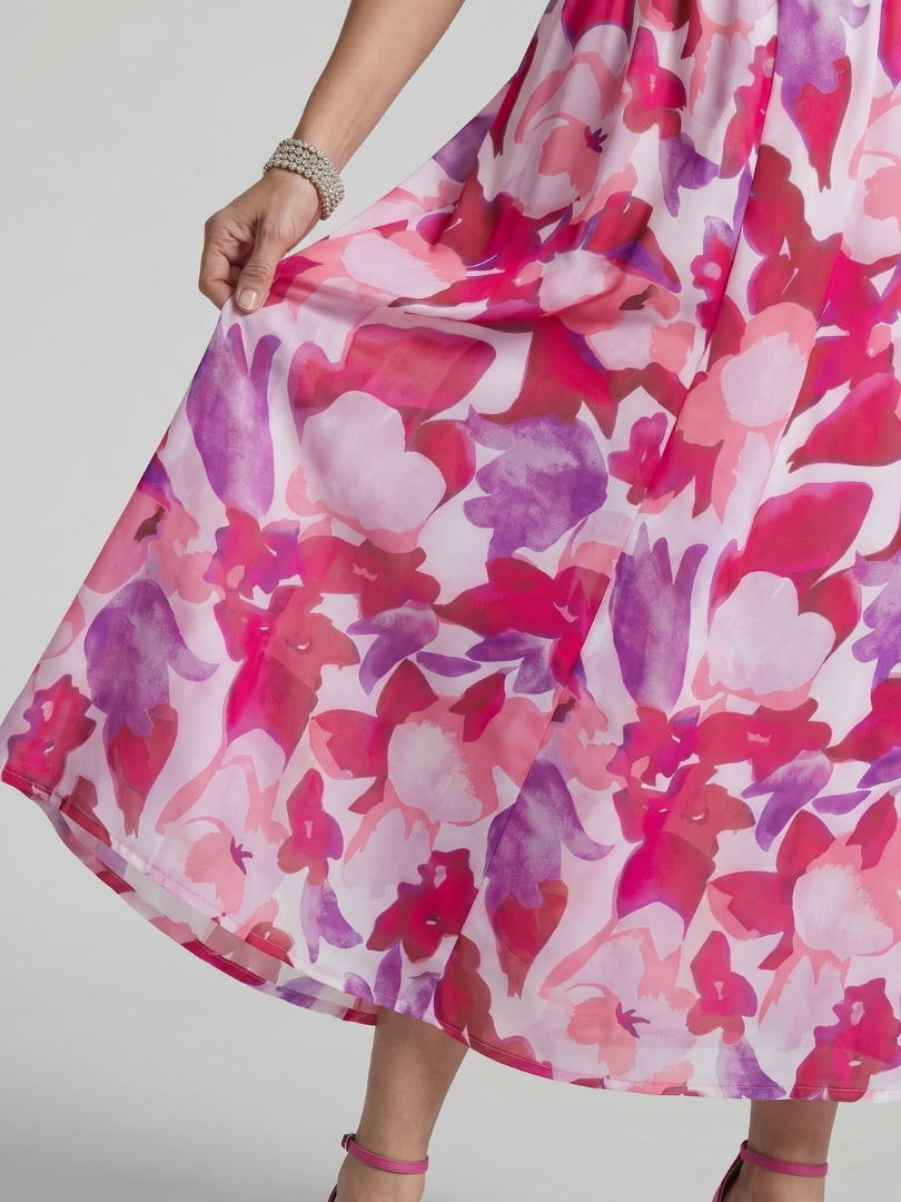 Close-up of abstract print and puff sleeves on this stylish women's V-neck midi dress, perfect for vacation.