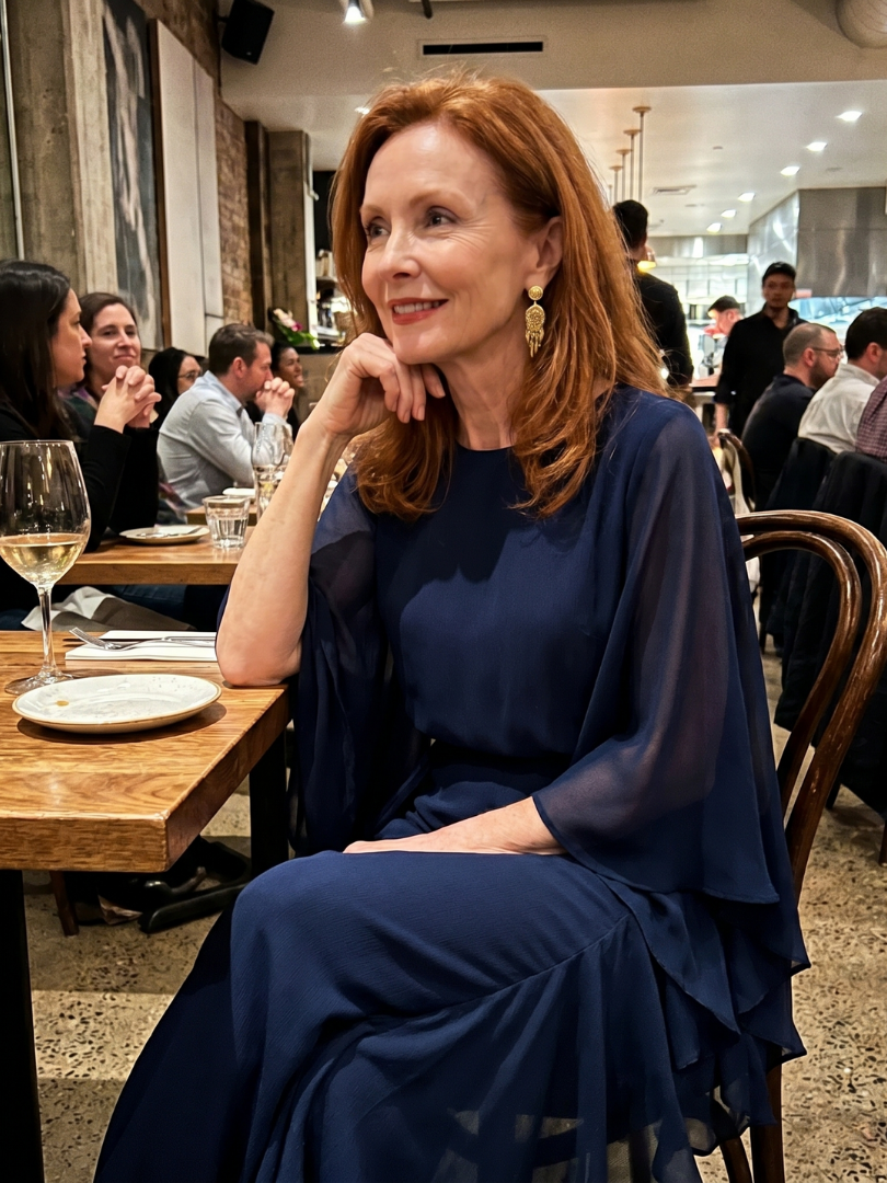 Fluid navy midi dress with elegant layered sleeves and a flattering drape waist. Women's sophisticated A-line style.