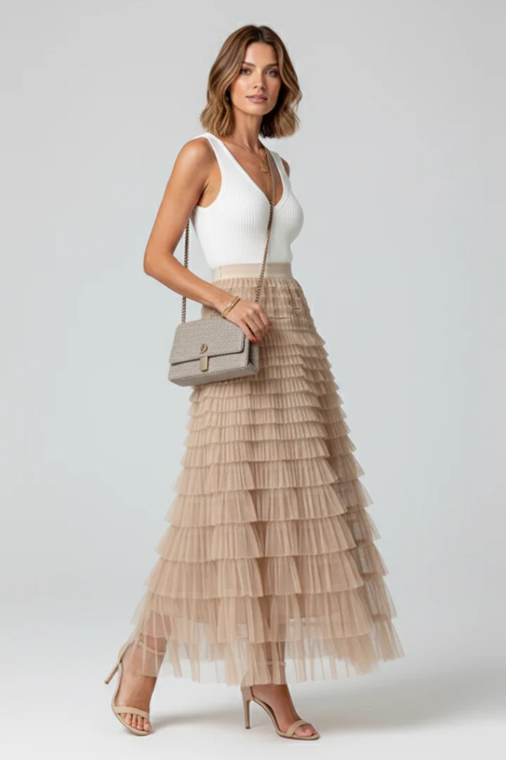 Elegant women's tiered midi skirt with a graceful layered design, ideal for evening wear or casual chic.