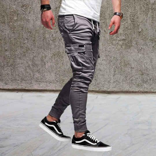 Outdoor-ready men's utility cargo pants with multiple flap pockets, blending style & practicality.