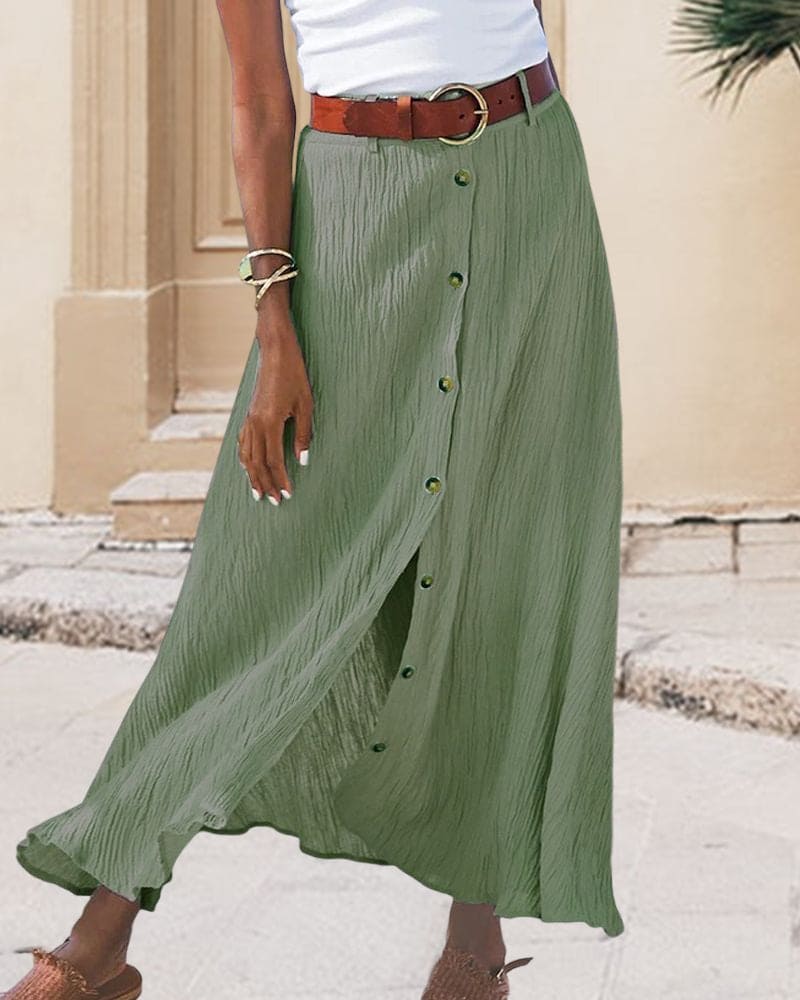 Close-up of a women's elegant button-front maxi skirt, highlighting the smooth fabric and detailed buttons.