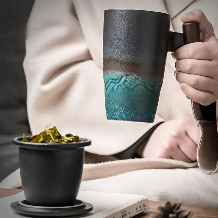 Handcrafted green ceramic tea mug with strainer; artistic design for loose leaf tea brewing.
