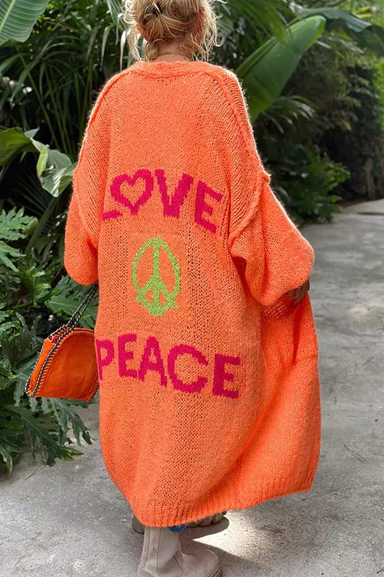 Women's oversized knit cardigan with colorful 'Love & Peace' print, perfect for a relaxed, boho-chic look.