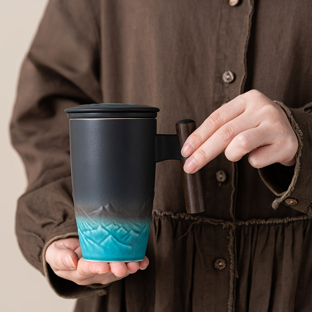 Versatile handmade ceramic mug with strainer, great for loose tea or coffee; artistic design.