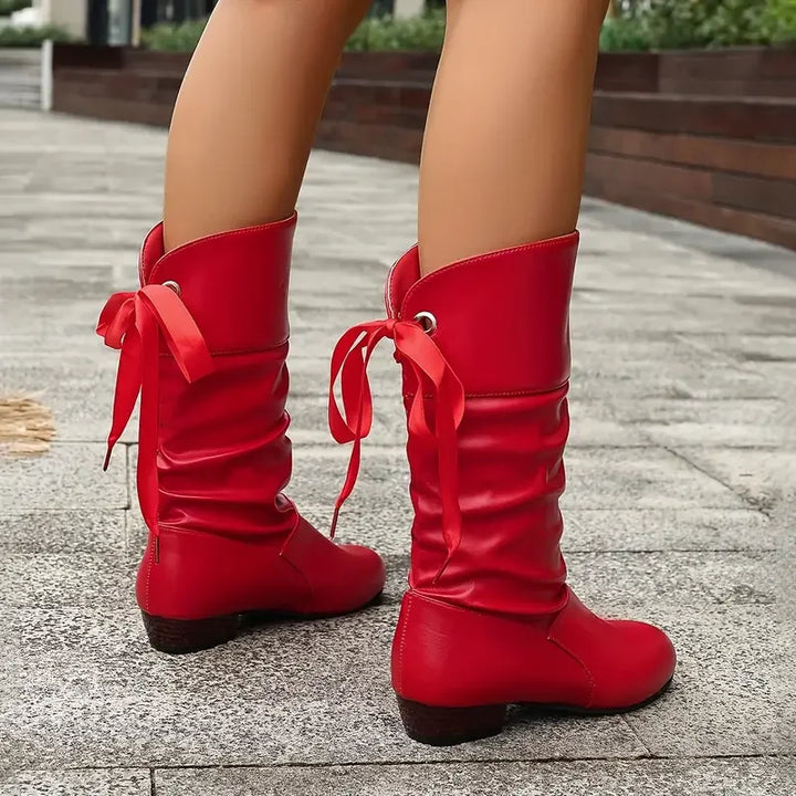 Side view of women's chunky heel calf boots with elegant lacing, ideal for winter style & comfort.