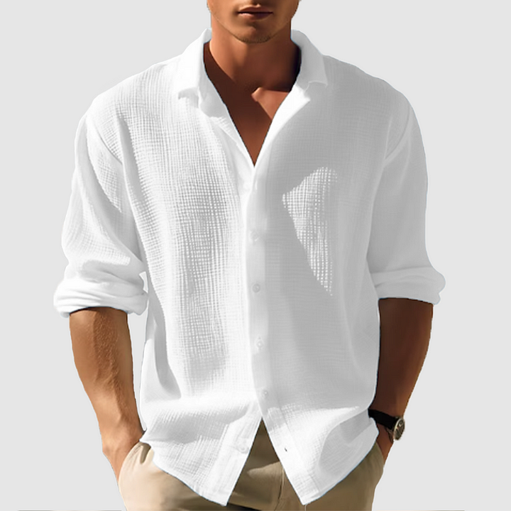Close-up of men's textured weave button-down shirt fabric, showing intricate pattern & long sleeve detail.
