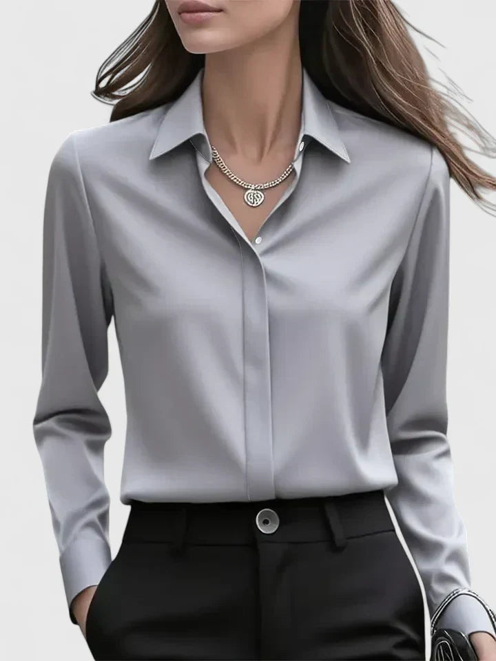 Women's elegant long sleeve button-down blouse, a versatile top with a chic curved hem for any occasion.