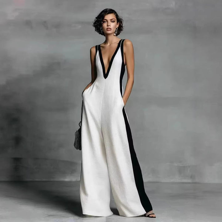 Elegant women's colour-block jumpsuit with V-neck, sleeveless design, and wide legs for smart casual or evening wear.