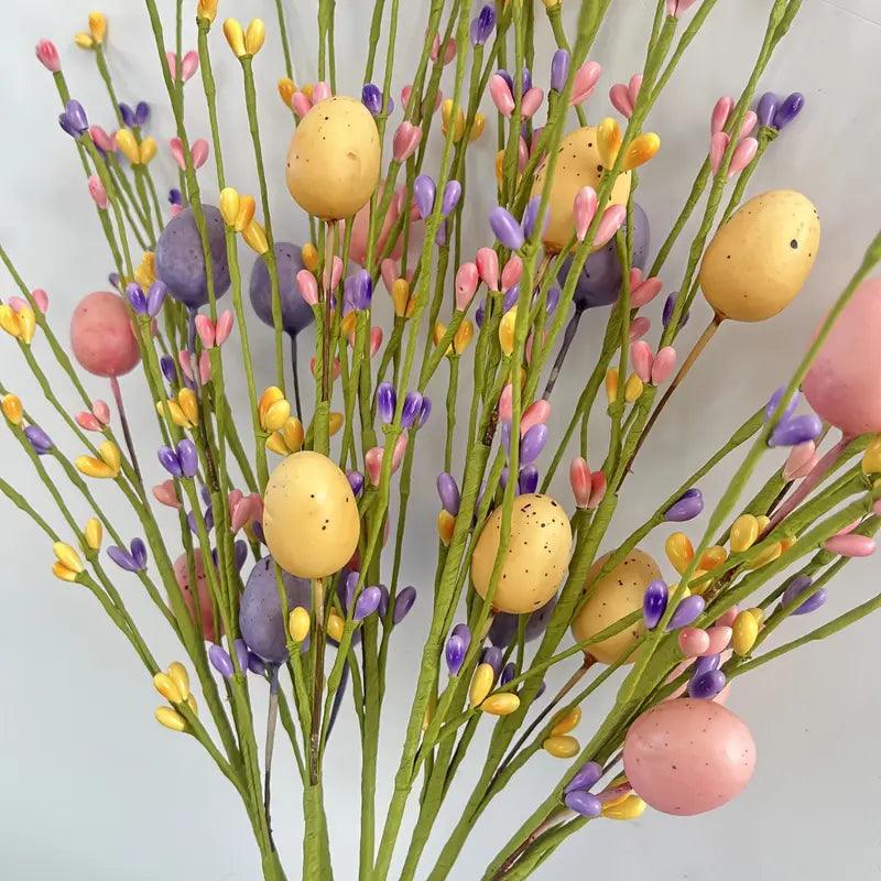 Decorative plastic Easter branches adorned with bright eggs, ideal as a spring table centerpiece.