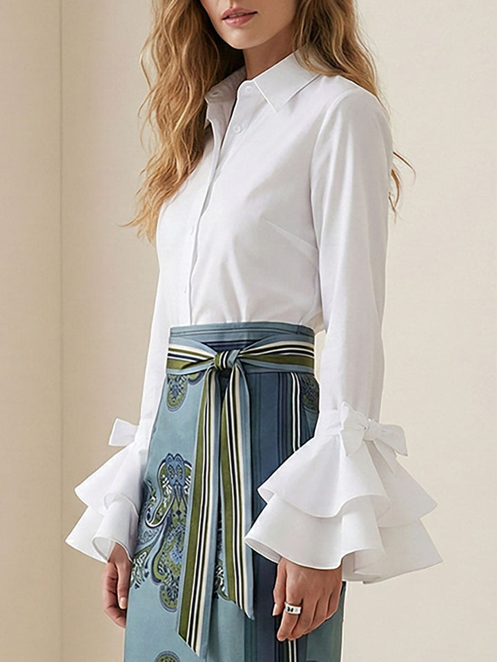 Elegant women's tiered ruffle blouse. Chic button-up top with flare sleeves for a sophisticated look.