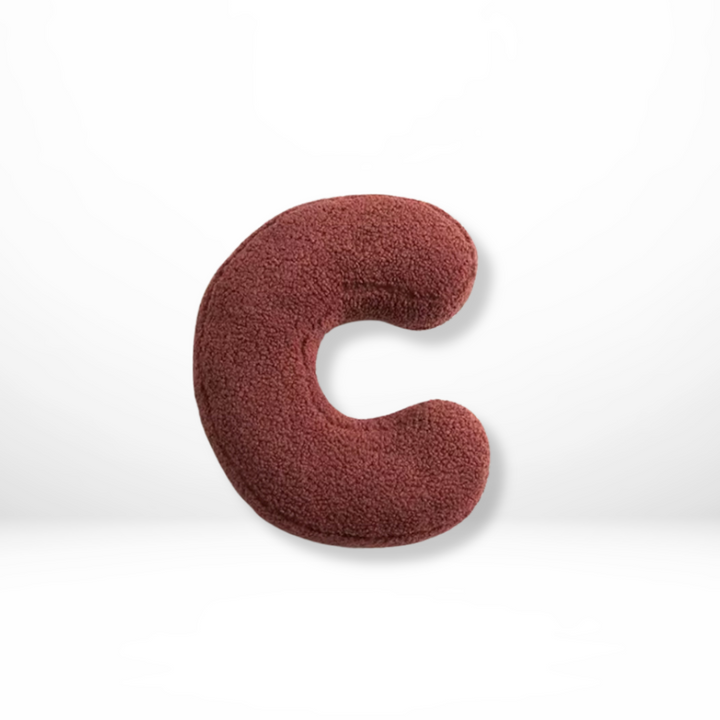 Decorative velvet 'G' alphabet cushion, a cozy soft furnishing for elegant home interior styling.