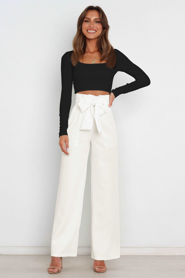 Women's elegant paperbag pants, high waist, wide leg, & distinctive bow accent.