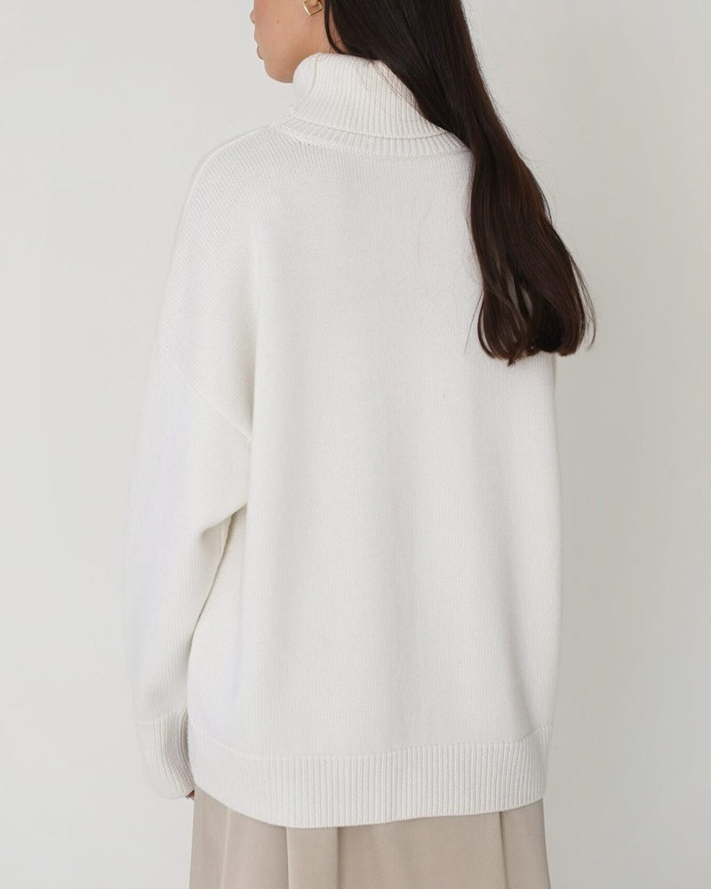 Stylish women's roll neck jumper with drop shoulder, chic & cozy for winter fashion.