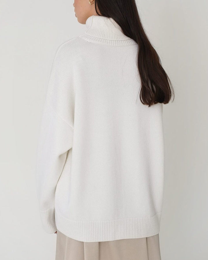 Stylish women's roll neck jumper with drop shoulder, chic & cozy for winter fashion.