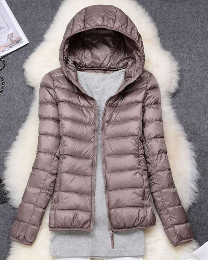 Women's lightweight waterproof rain jacket for all-weather protection. Ideal for outdoor comfort & style.